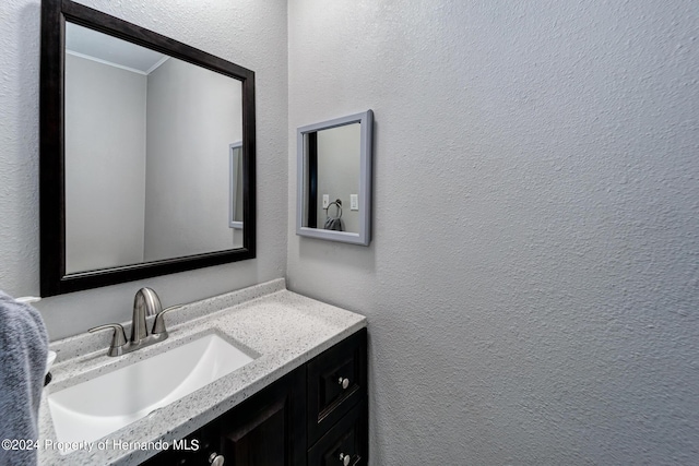 6635 Stewart Ave N, Saint Petersburg, FL 33702 - bathroom with a textured wall, ornamental molding, and vanity