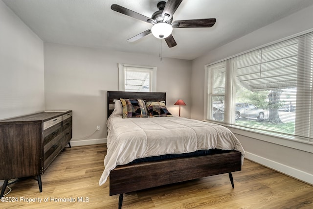 bedroom with light wood-type flooring and ceiling fan