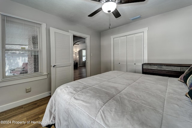 6635 Stewart Ave N, Saint Petersburg, FL 33702 - bedroom with wood finished floors, baseboards, a closet, a ceiling fan, and arched walkways