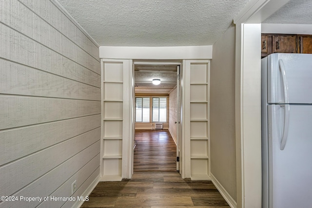 6635 Stewart Ave N, Saint Petersburg, FL 33702 - corridor with a textured ceiling, dark wood-style floors, and wood walls