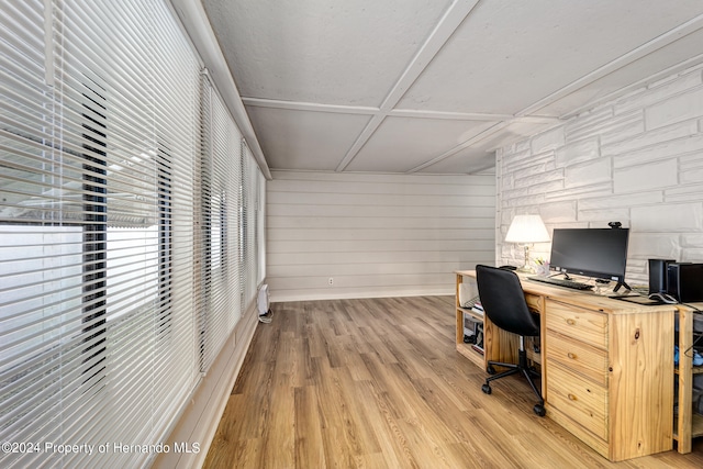 office space featuring light hardwood / wood-style flooring and wooden walls