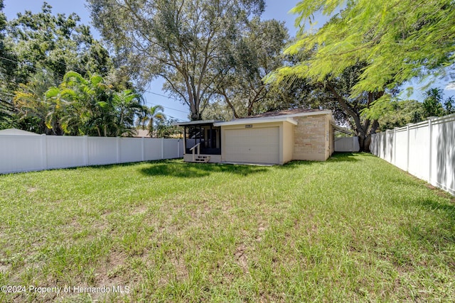 6635 Stewart Ave N, Saint Petersburg, FL 33702 - view of yard with a sunroom and an attached garage