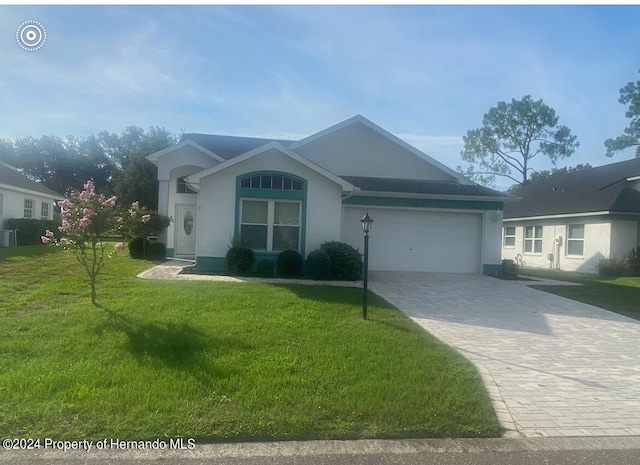 view of front of home with a garage and a front yard