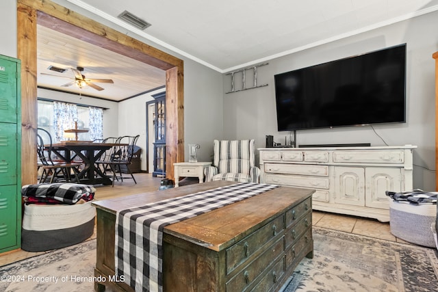 living room featuring ornamental molding, light wood-type flooring, and ceiling fan