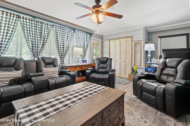 tiled living room with a healthy amount of sunlight, crown molding, and ceiling fan