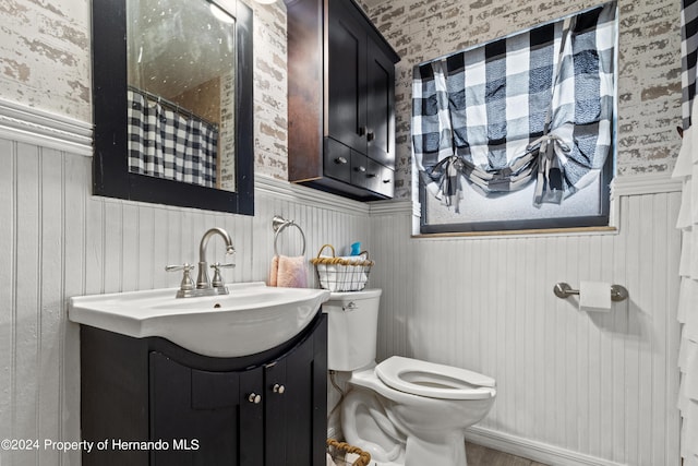 bathroom with vanity, toilet, and a shower with curtain