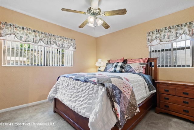 bedroom featuring ceiling fan and light colored carpet