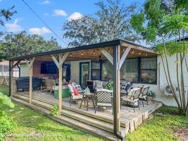 rear view of house featuring an outdoor living space and a wooden deck