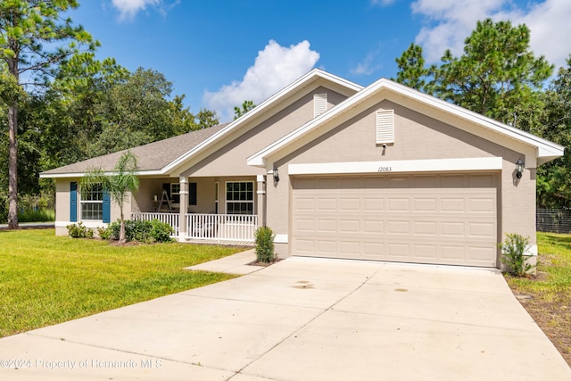 ranch-style home with a garage, a front yard, and covered porch