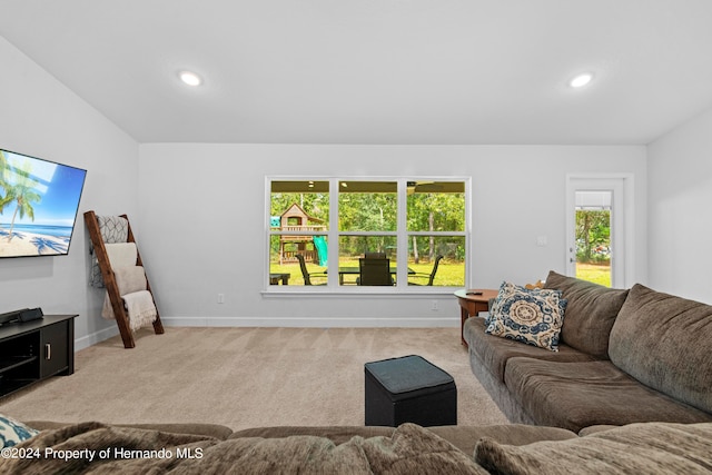 carpeted living room featuring lofted ceiling