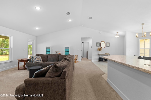 carpeted living room featuring vaulted ceiling and an inviting chandelier