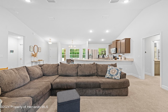 carpeted living room with lofted ceiling, a chandelier, and sink