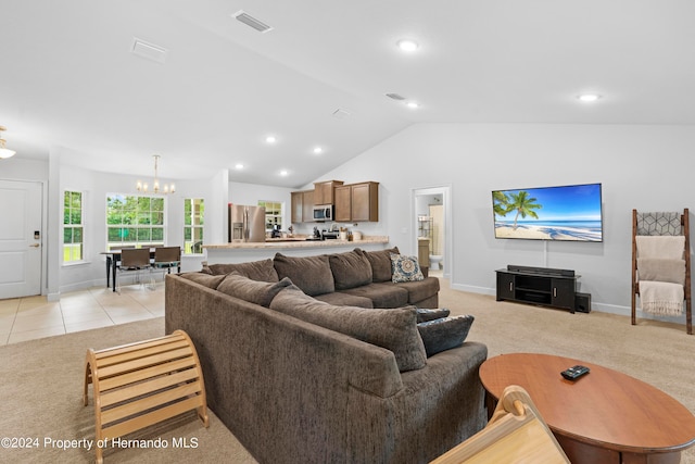 carpeted living room featuring a chandelier and vaulted ceiling