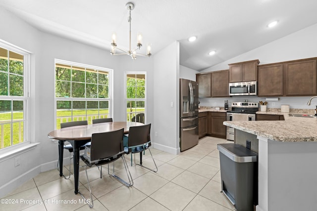 kitchen featuring plenty of natural light, appliances with stainless steel finishes, and hanging light fixtures