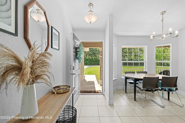 interior space featuring light tile patterned floors and an inviting chandelier