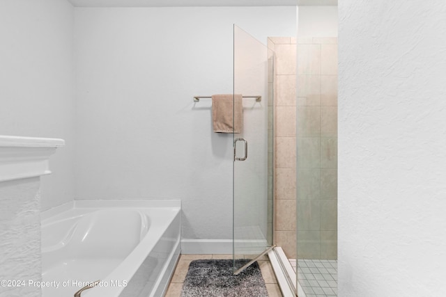 bathroom with shower with separate bathtub and tile patterned floors