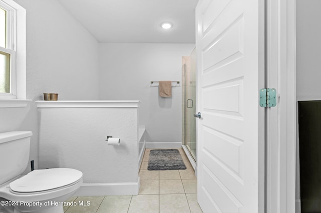 bathroom featuring walk in shower, tile patterned flooring, and toilet