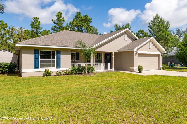 single story home with a front yard, a garage, and covered porch