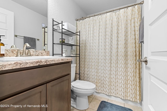 bathroom featuring toilet, vanity, and tile patterned floors