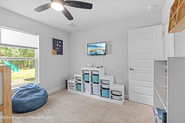 interior space featuring ceiling fan and light carpet