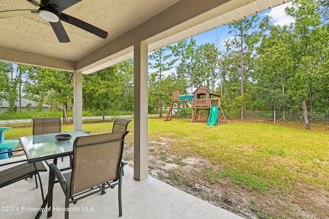 view of patio featuring a playground and ceiling fan