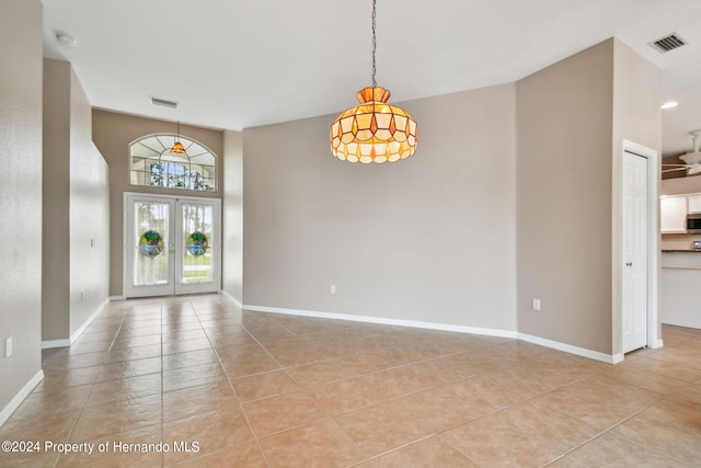 foyer entrance with french doors, light tile patterned flooring, and ceiling fan