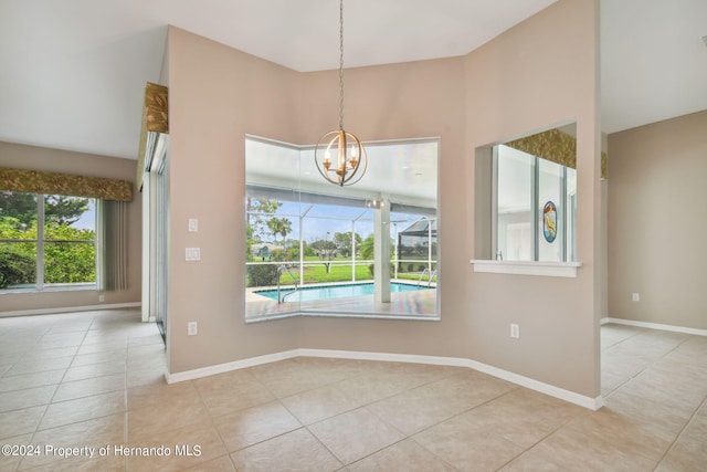 unfurnished dining area featuring an inviting chandelier and light tile patterned floors