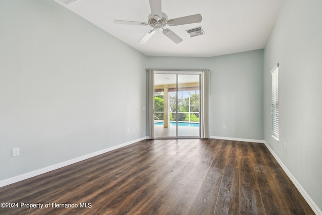 spare room featuring dark hardwood / wood-style flooring and ceiling fan