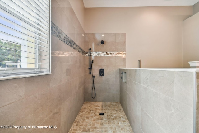 bathroom with tiled shower