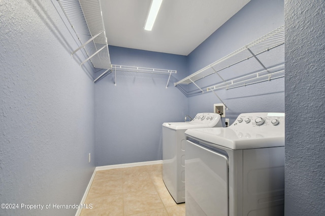 laundry room featuring separate washer and dryer and light tile patterned floors