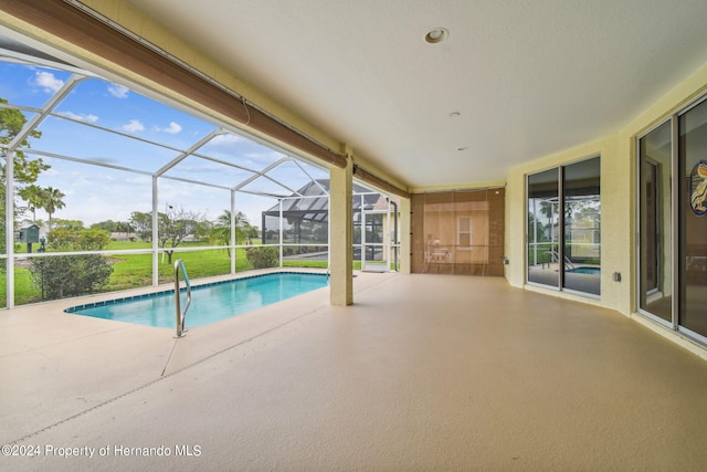 view of swimming pool with a lanai and a patio area