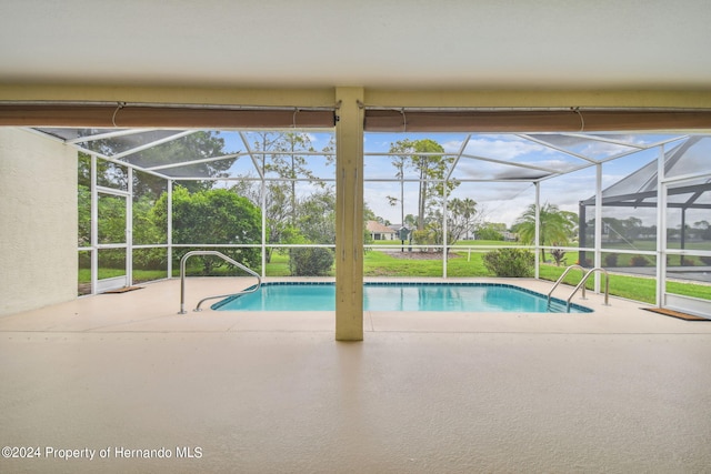 view of pool with a lanai and a patio