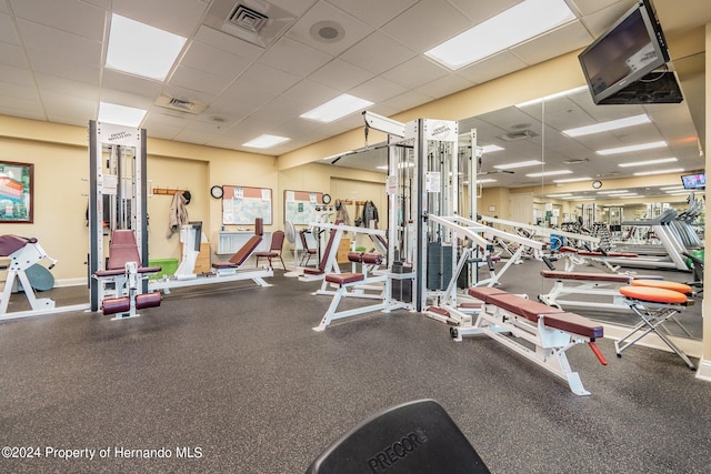 gym featuring a paneled ceiling