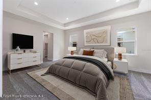 bedroom featuring dark wood-type flooring and a tray ceiling