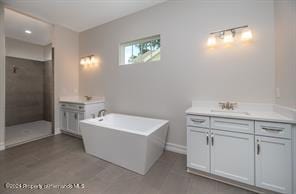 bathroom featuring hardwood / wood-style flooring, vanity, and plus walk in shower