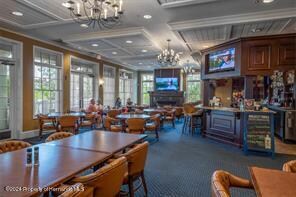 carpeted dining space featuring ornamental molding, beam ceiling, and coffered ceiling