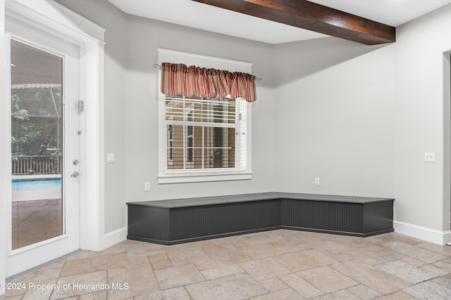 spare room with beam ceiling