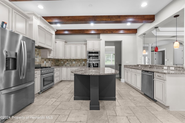 kitchen featuring beamed ceiling, white cabinetry, kitchen peninsula, light stone counters, and appliances with stainless steel finishes