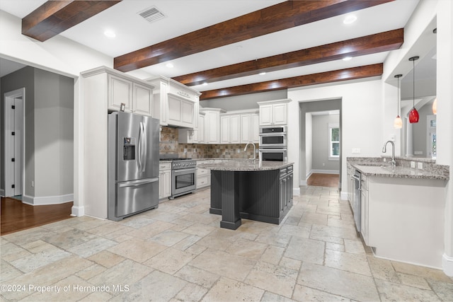 kitchen with white cabinetry, light stone counters, appliances with stainless steel finishes, beam ceiling, and decorative backsplash