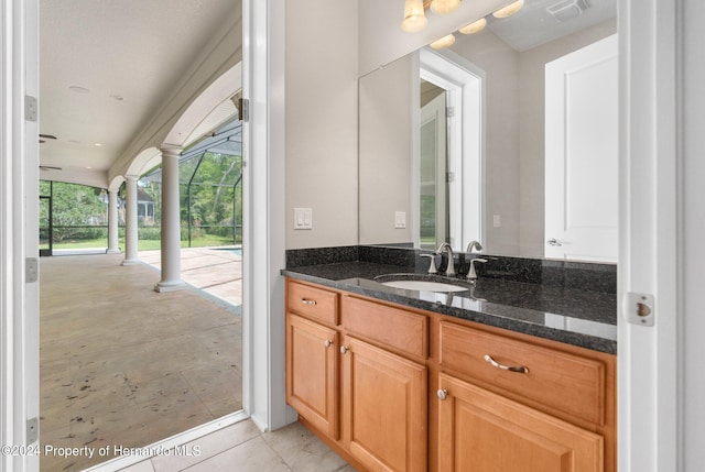 bathroom with ornate columns and vanity