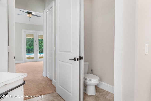 bathroom with french doors, tile patterned floors, toilet, vanity, and ceiling fan