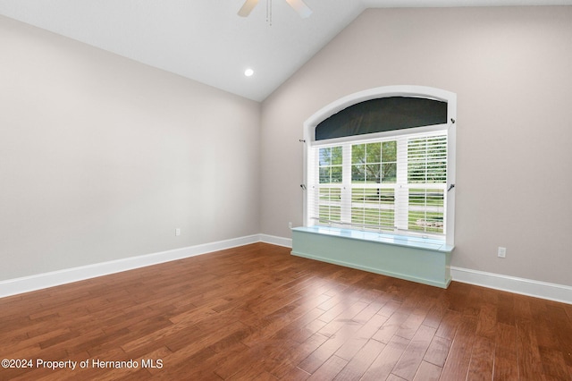 unfurnished room with lofted ceiling, dark wood-type flooring, and ceiling fan