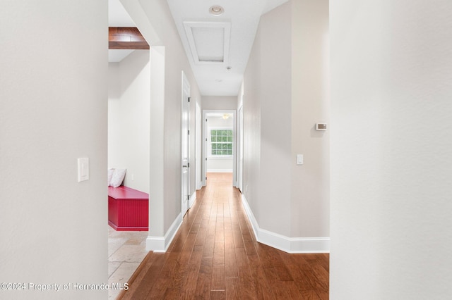 hallway with hardwood / wood-style floors