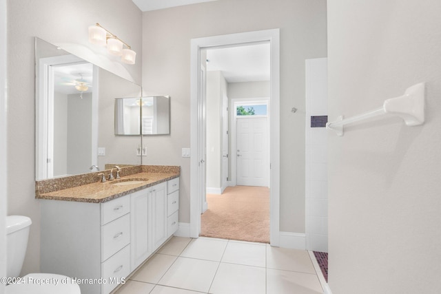 bathroom with vanity, ceiling fan, tile patterned flooring, and toilet