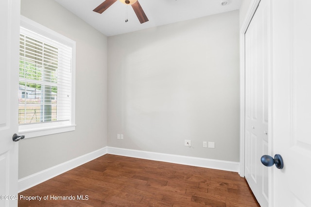 unfurnished bedroom featuring wood-type flooring, ceiling fan, and a closet