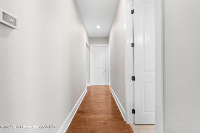 corridor with light wood-type flooring