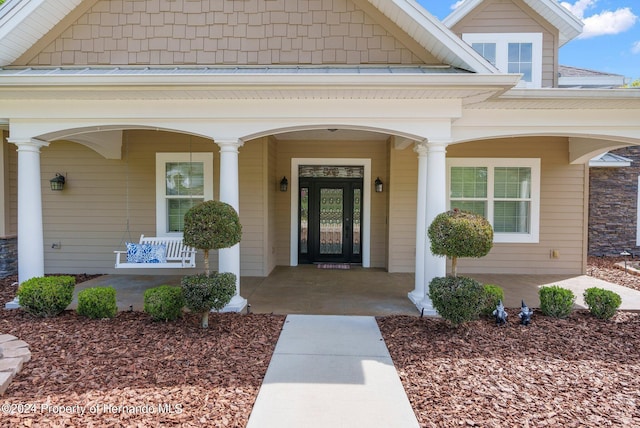 doorway to property with a porch