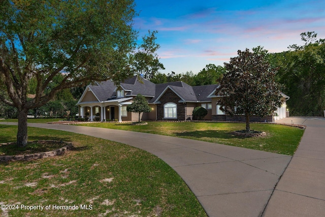 view of front of property with a garage and a yard