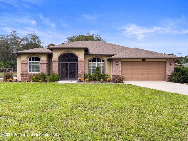 view of front facade with a garage and a front yard