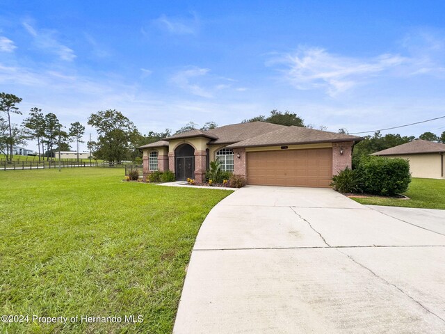 view of front of house featuring a garage and a front yard